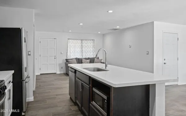a kitchen with a sink a stove and a refrigerator