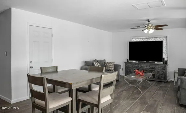 a view of a dining room with furniture wooden floor and a flat screen tv