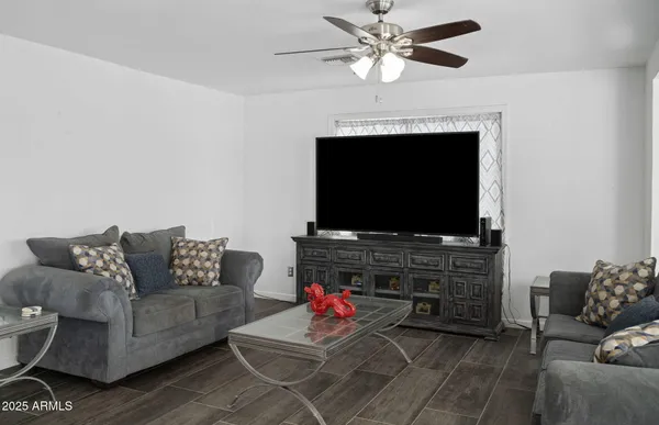 a living room with furniture and a flat screen tv