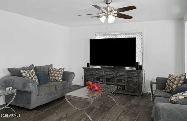 a living room with furniture and a flat screen tv