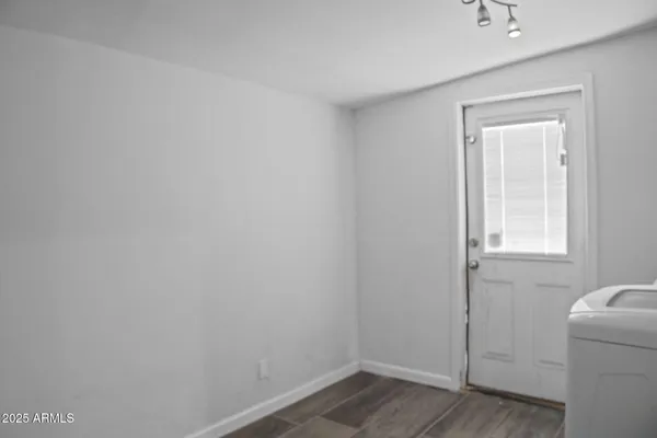 a view of a room with wooden floor and cabinet