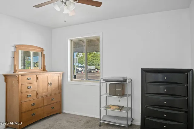 a room with a dresser and a window