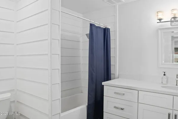 a bathroom with a shower and a sink