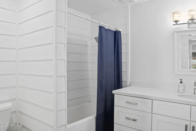 a bathroom with a shower and a sink