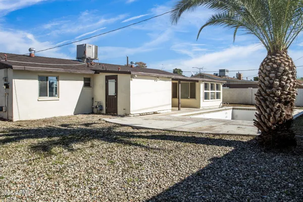 a view of a house with a snow on the wall and a yard