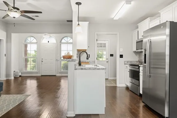 a kitchen with a refrigerator and a stove