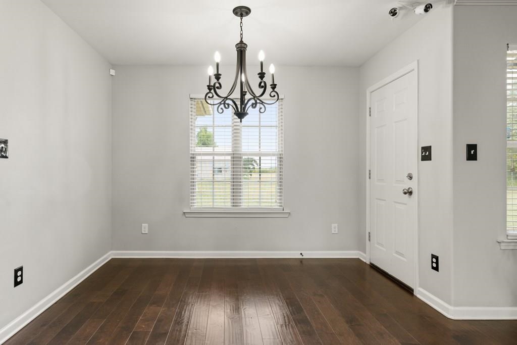 13854 Highway 70 Proctor, AR 72376 - Photo 13 of 31 wooden floor in an empty room with a window