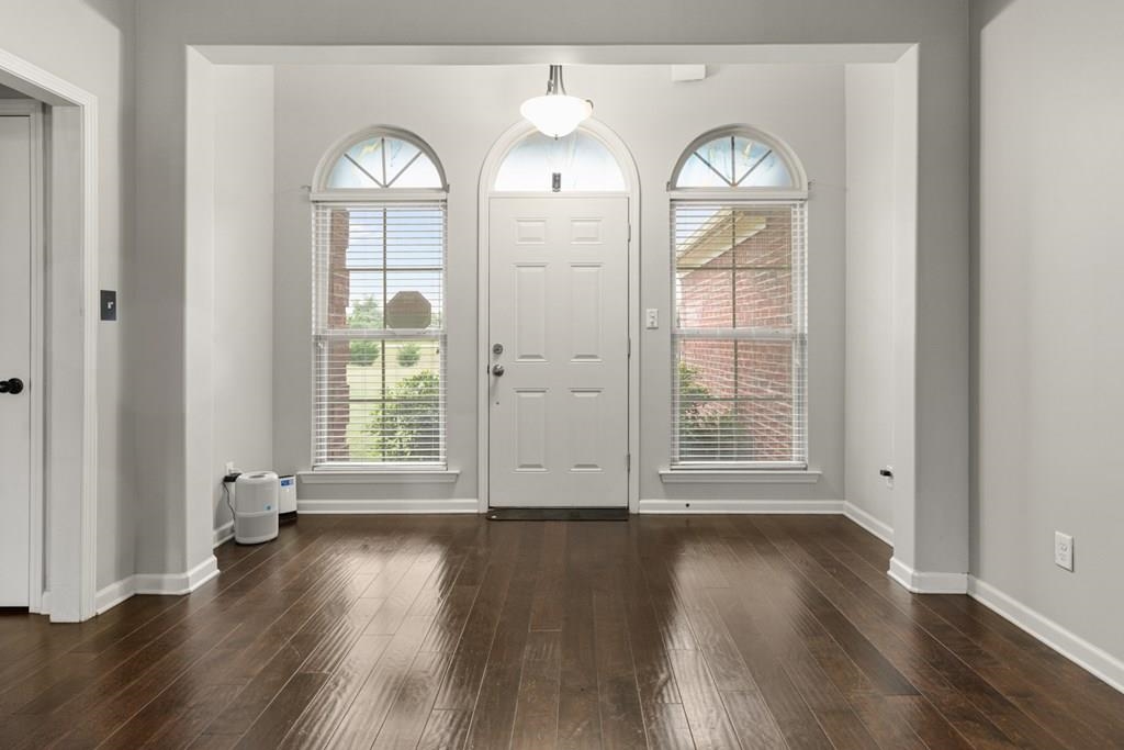 13854 Highway 70 Proctor, AR 72376 - Photo 14 of 31 an empty room with wooden floor mirror and windows