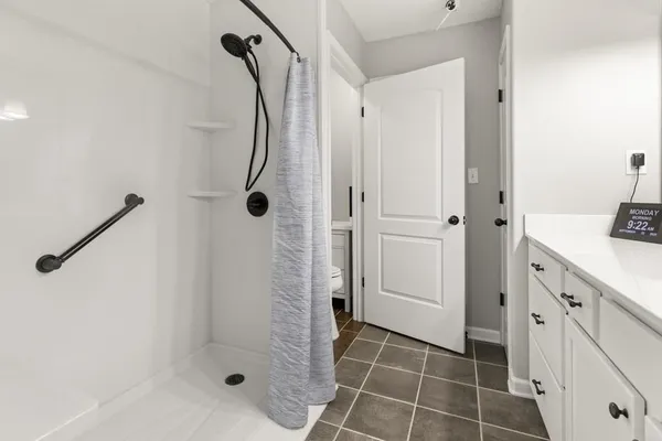 a bathroom with a shower and a sink