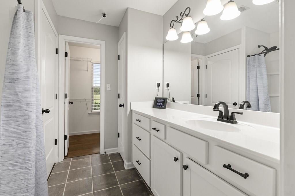 13854 Highway 70 Proctor, AR 72376 - Photo 17 of 31 a bathroom with a double vanity sink mirror and shower