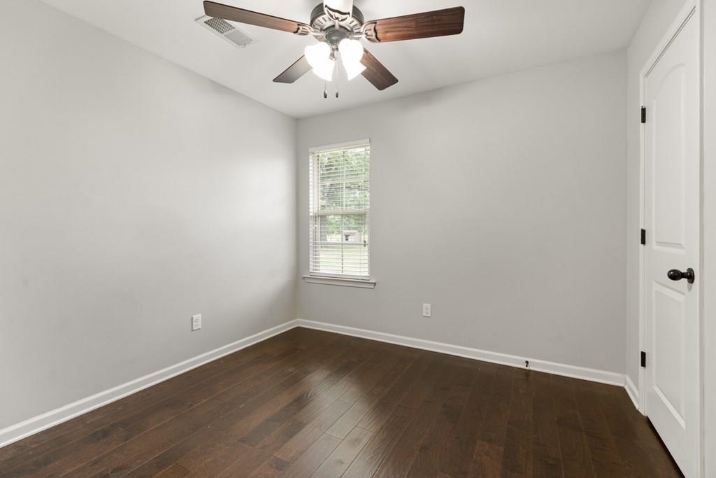 13854 Highway 70 Proctor, AR 72376 - Photo 18 of 31 an empty room with wooden floor fan and windows
