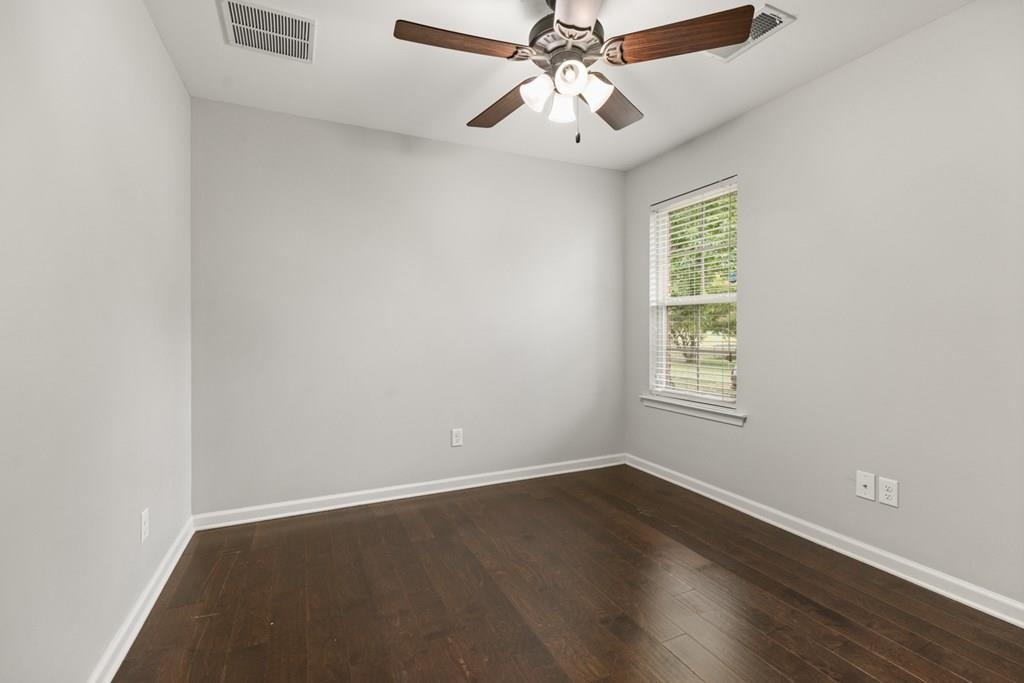 13854 Highway 70 Proctor, AR 72376 - Photo 20 of 31 an empty room with wooden floor and windows
