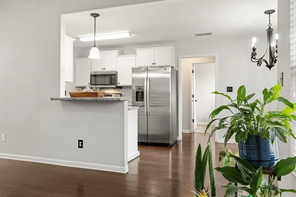 a kitchen with stainless steel appliances a refrigerator a sink a stove a cabinets and wooden floor