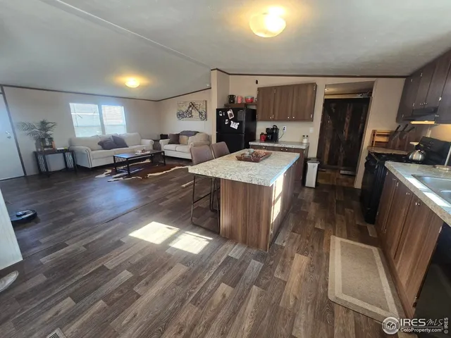 a kitchen with sink refrigerator and window
