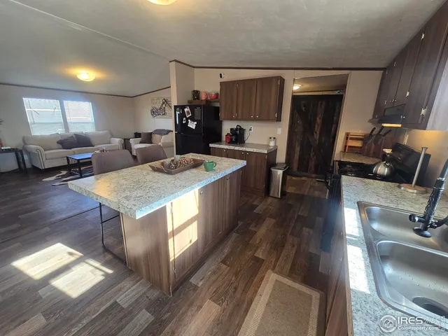 a kitchen with sink refrigerator and window