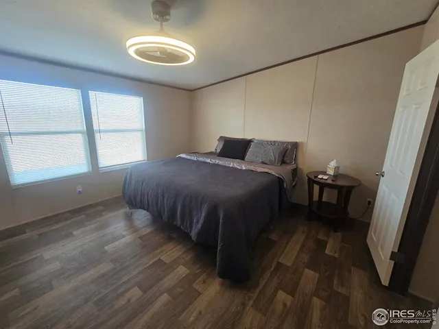 a bedroom with a bed and a large window