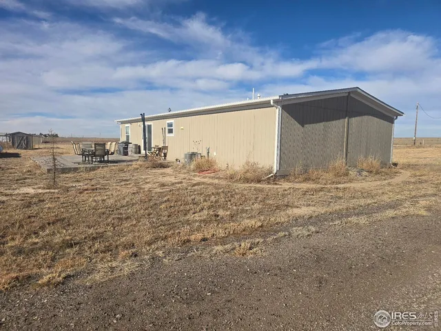 a view of large parking space with wooden fence