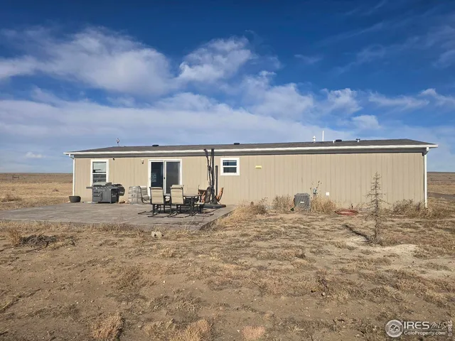 a view of a house with backyard porch and sitting area