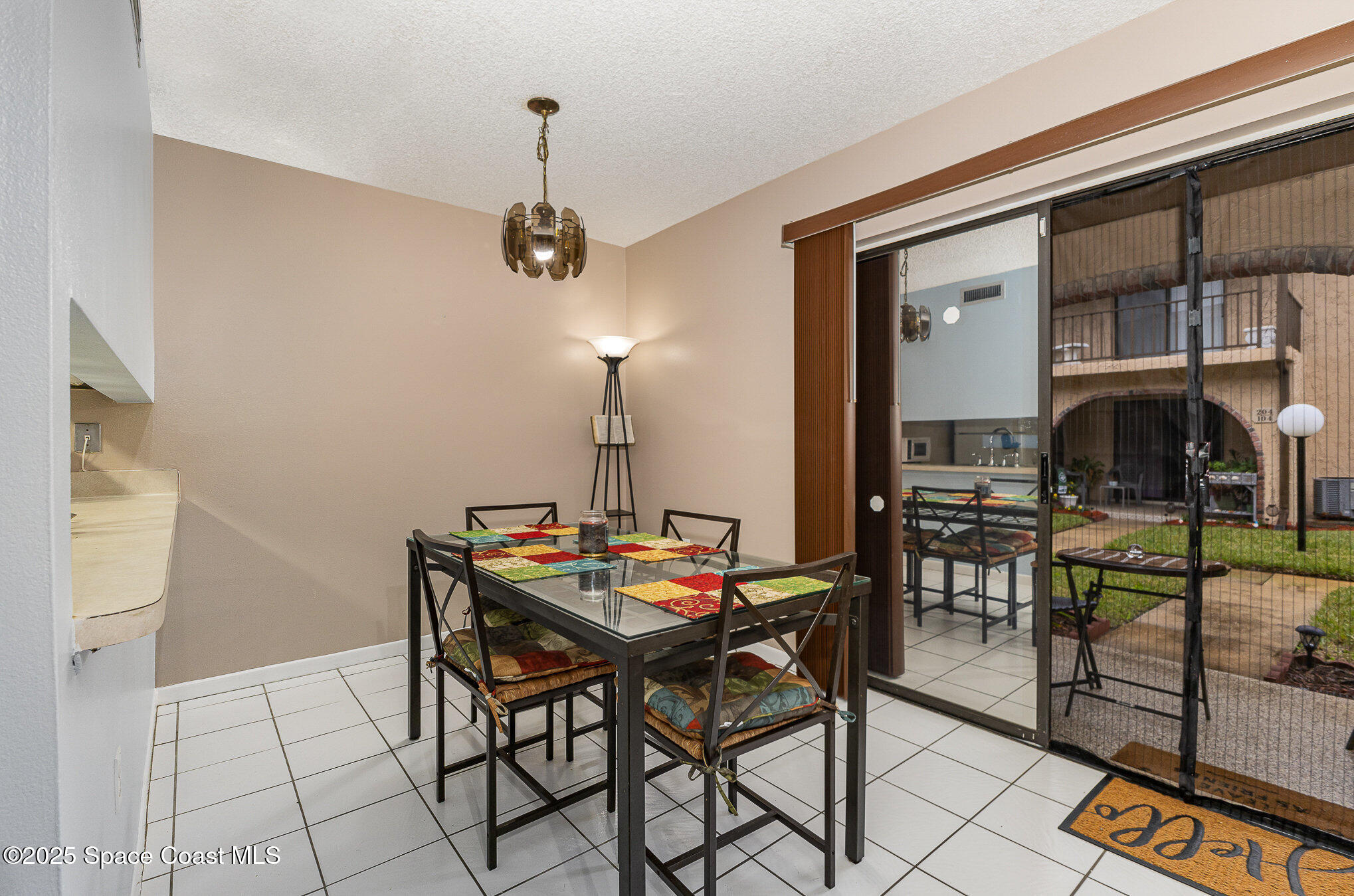 109 San Paulo Circle, Unit 15109 West Melbourne, FL 32904 - Photo 11 of 30 a dining room with furniture and a floor to ceiling window