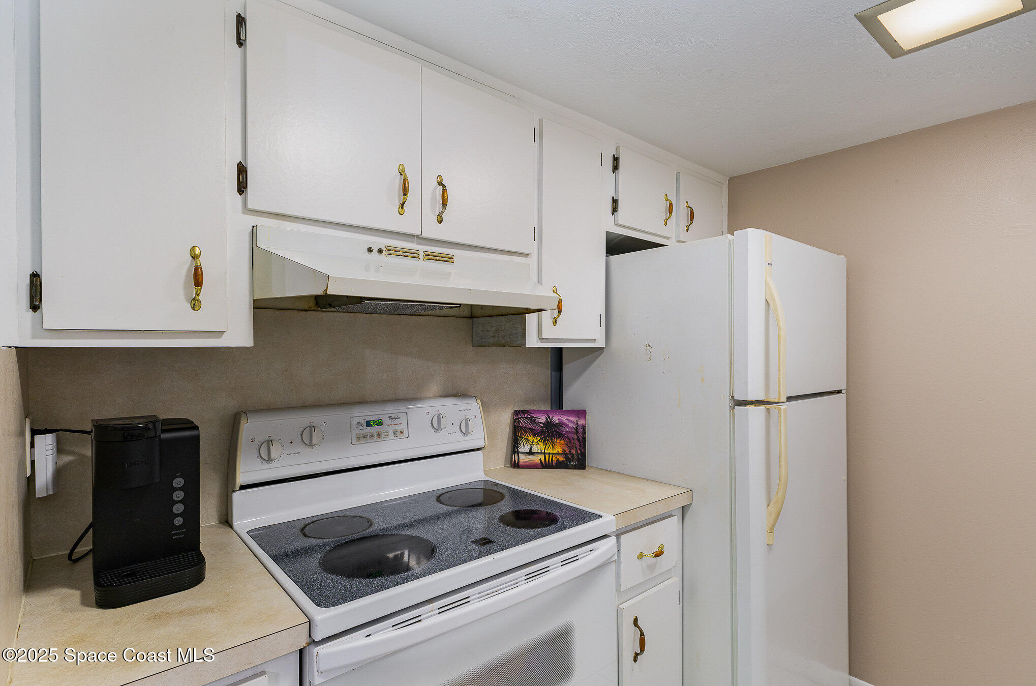 109 San Paulo Circle, Unit 15109 West Melbourne, FL 32904 - Photo 14 of 30 a white refrigerator freezer sitting in a kitchen