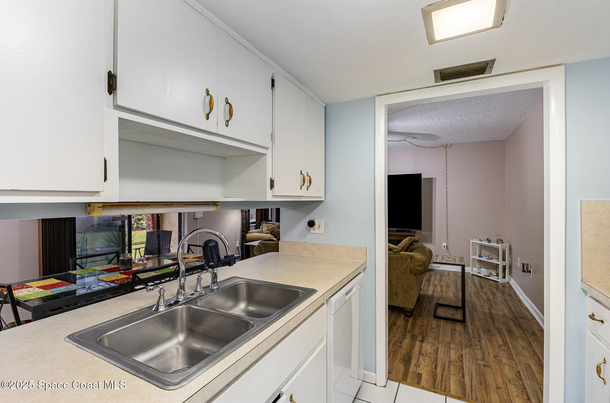 109 San Paulo Circle, Unit 15109 West Melbourne, FL 32904 - Photo 15 of 30 a kitchen with a sink dishwasher a stove and a refrigerator with wooden floor