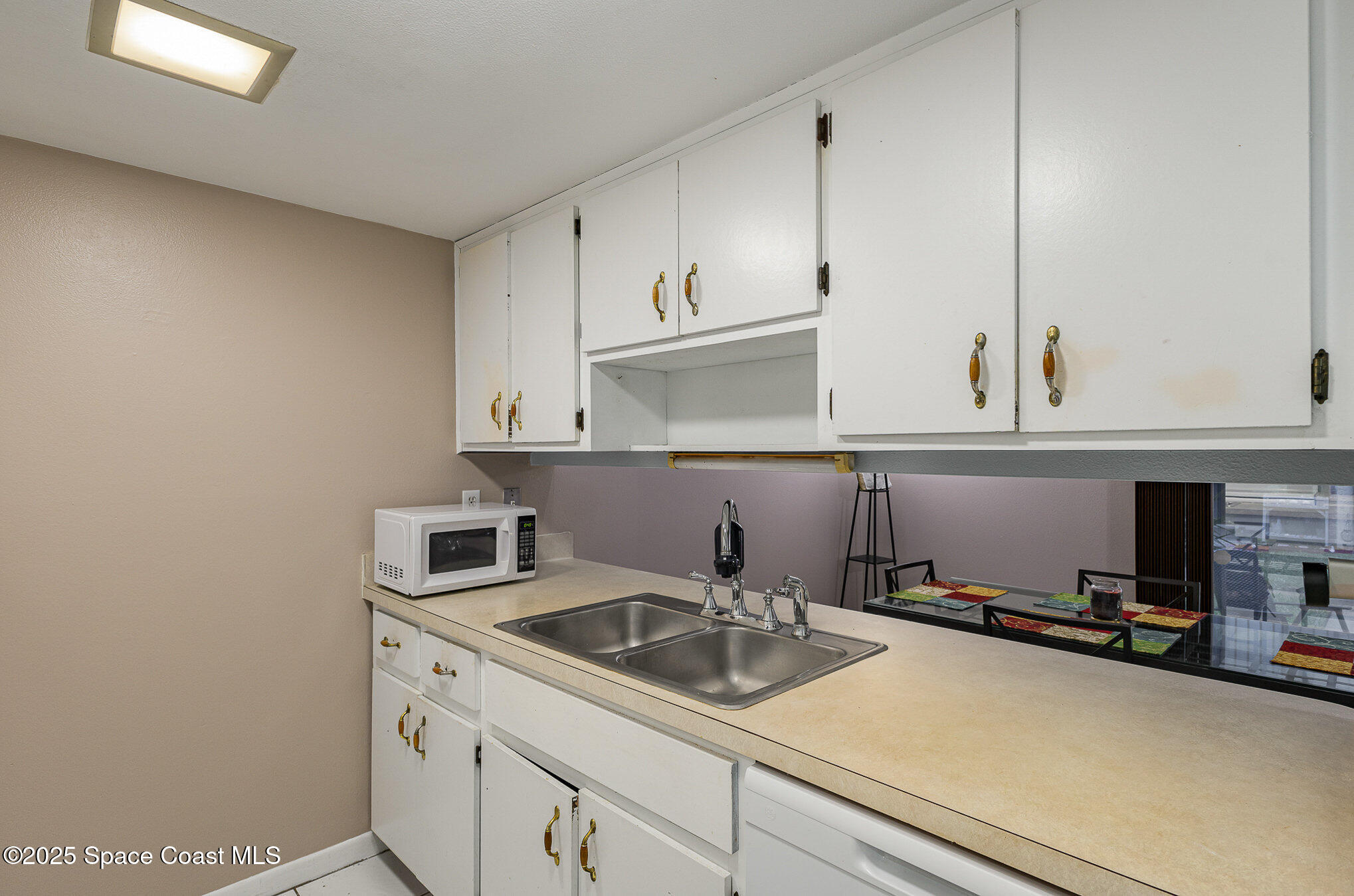 109 San Paulo Circle, Unit 15109 West Melbourne, FL 32904 - Photo 16 of 30 a kitchen with a sink and cabinets