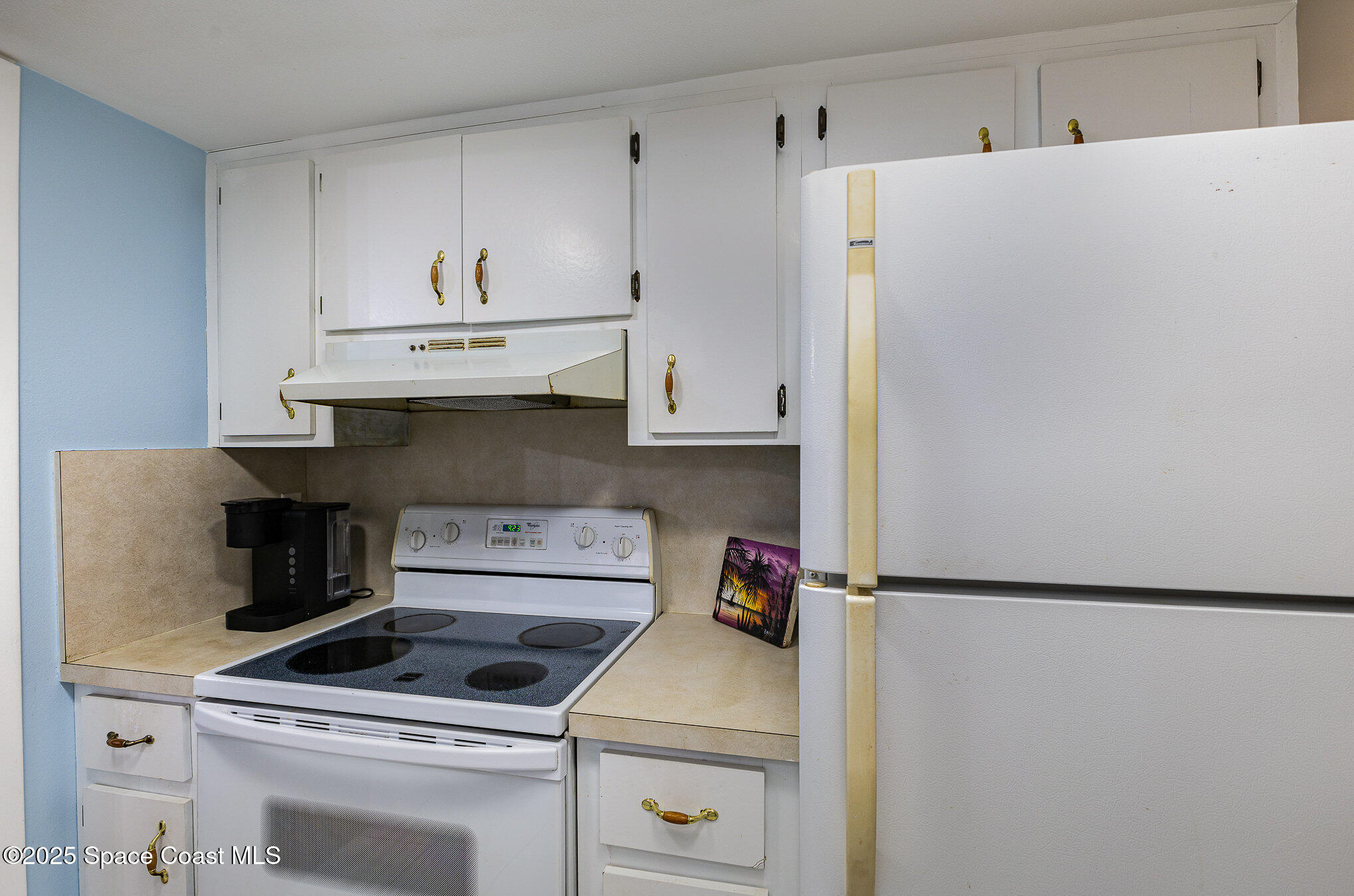 109 San Paulo Circle, Unit 15109 West Melbourne, FL 32904 - Photo 17 of 30 a kitchen with white cabinets and white appliances