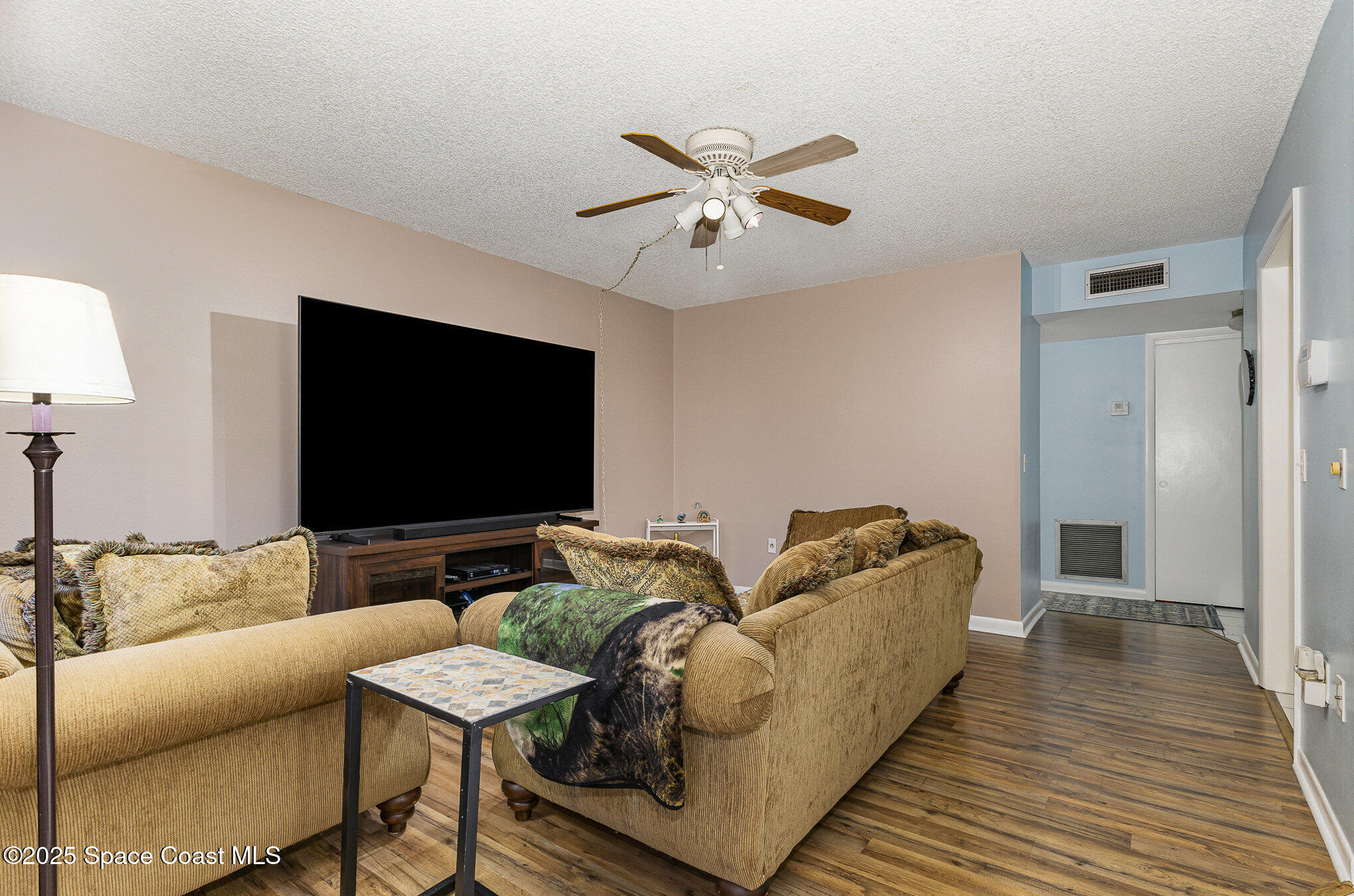 109 San Paulo Circle, Unit 15109 West Melbourne, FL 32904 - Photo 2 of 30 a living room with furniture and a flat screen tv