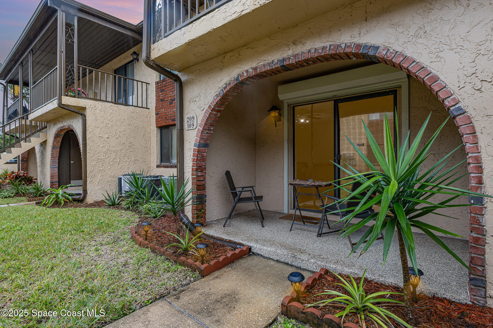 109 San Paulo Circle, Unit 15109 West Melbourne, FL 32904 - Photo 26 of 30 a front view of a house with garden