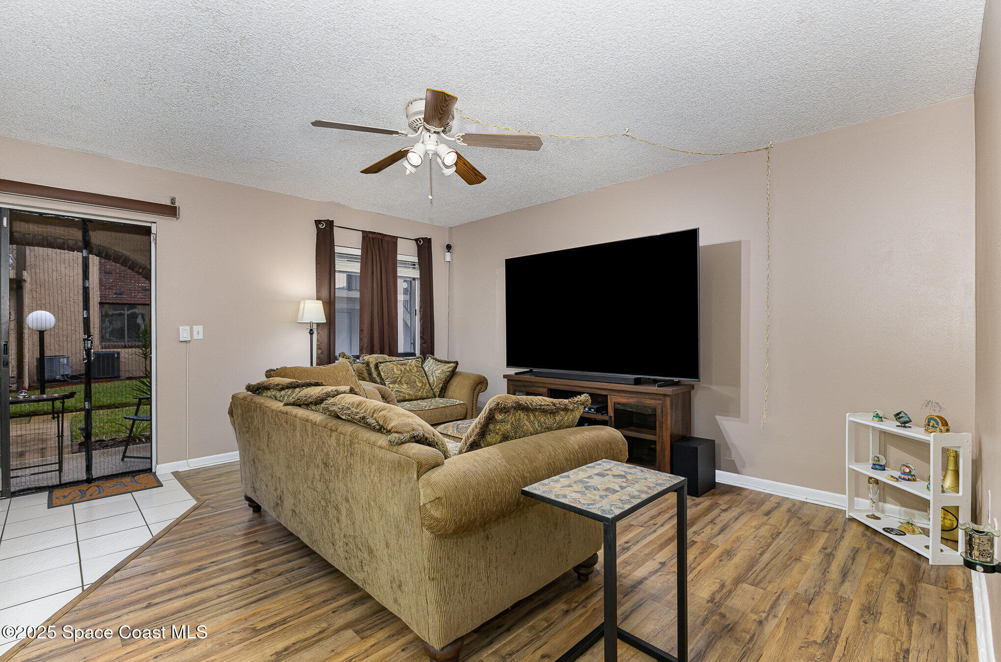 109 San Paulo Circle, Unit 15109 West Melbourne, FL 32904 - Photo 3 of 30 a living room with furniture and a flat screen tv