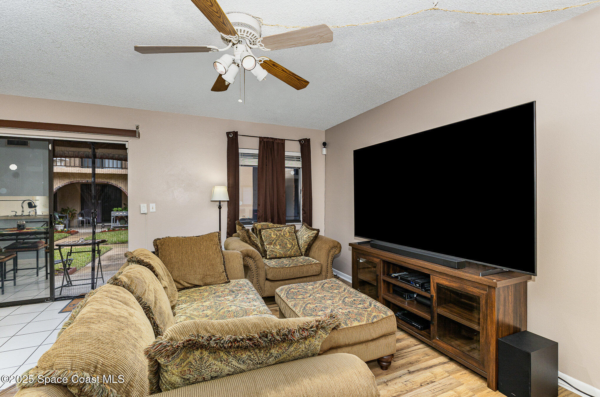 109 San Paulo Circle, Unit 15109 West Melbourne, FL 32904 - Photo 5 of 30 a living room with furniture and a flat screen tv
