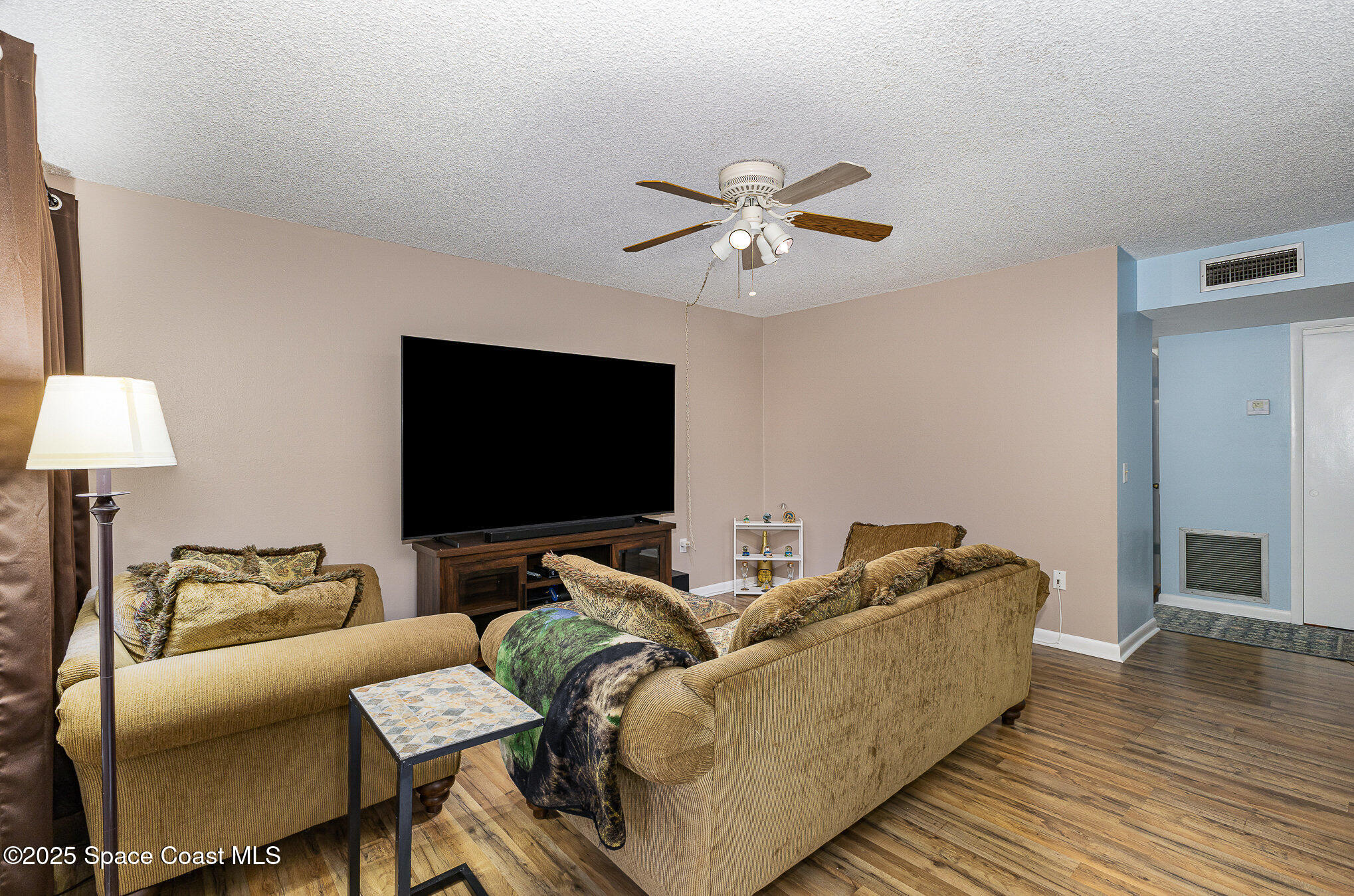 109 San Paulo Circle, Unit 15109 West Melbourne, FL 32904 - Photo 8 of 30 a living room with furniture and a flat screen tv