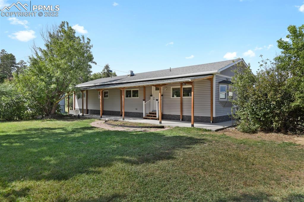 a big room with table and chairs and large trees