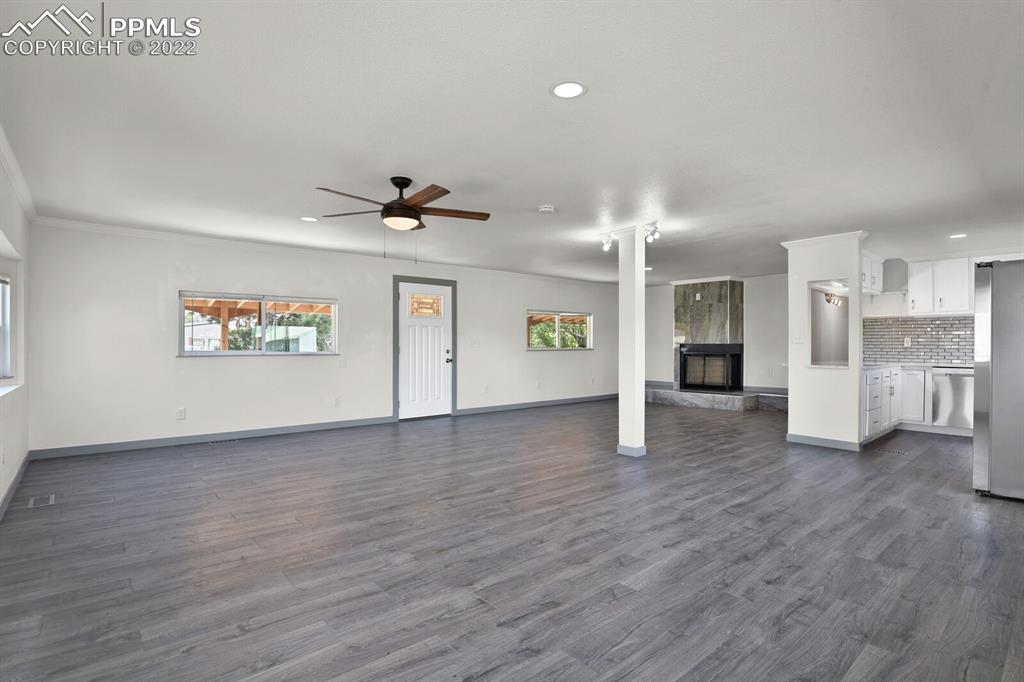 24365 Elbert Road Elbert, CO 80106 - Photo 5 of 19 a view of a big room with wooden floor and a kitchen
