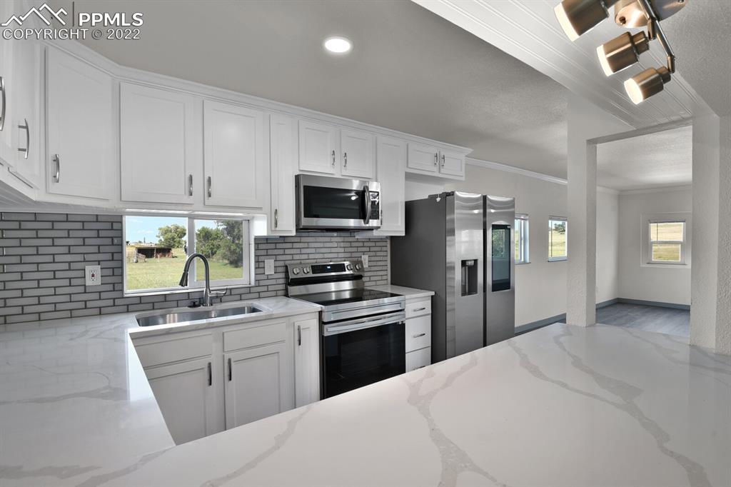24365 Elbert Road Elbert, CO 80106 - Photo 7 of 19 a kitchen with a sink stainless steel appliances and cabinets