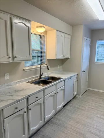 a kitchen with sink and cabinets