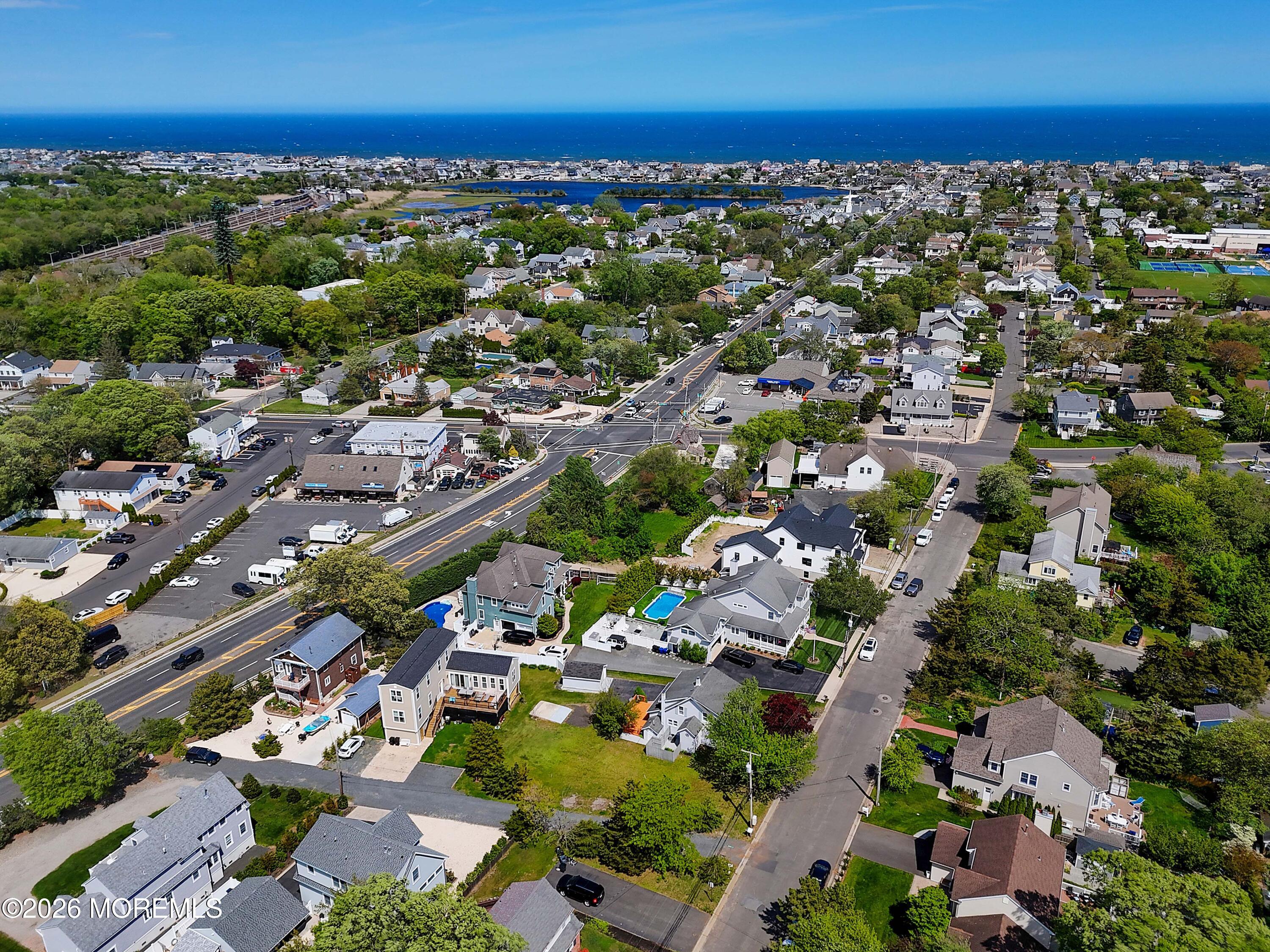 715 Howe Street Point Pleasant, NJ 08742 - Photo 32 of 45 an aerial view of a city with lots of residential buildings and ocean view in back
