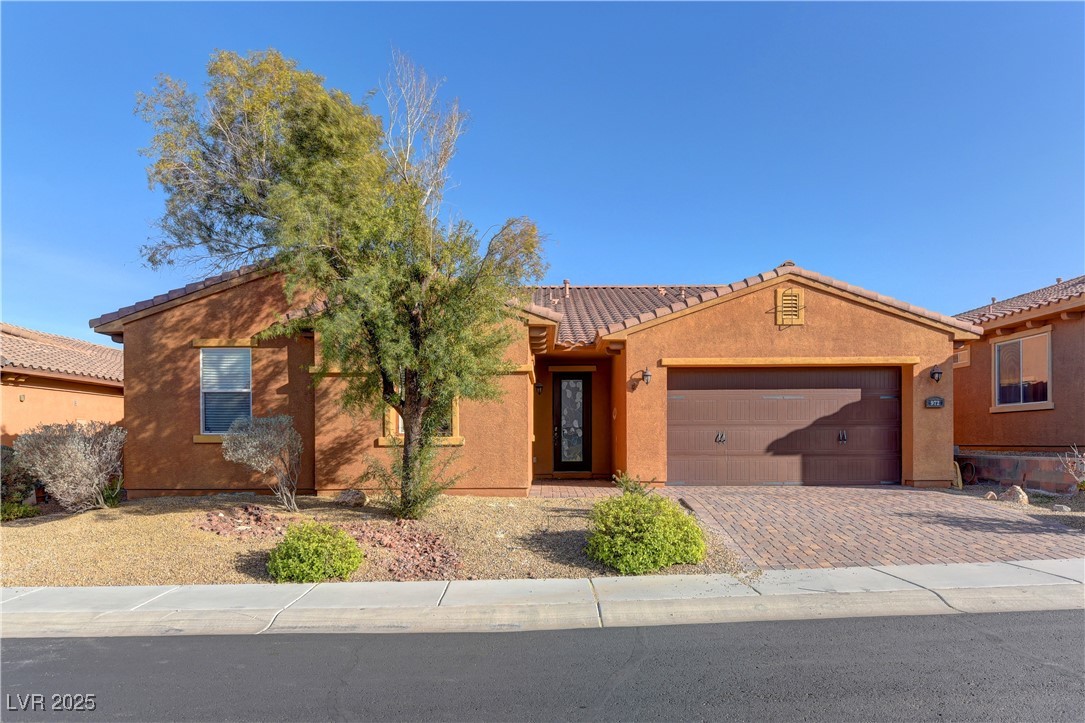 972 Rue Grand Paradis Lane Henderson, NV 89011 - Photo 1 of 32 View of front of home featuring stucco siding, a tiled roof, driveway, and a garage
