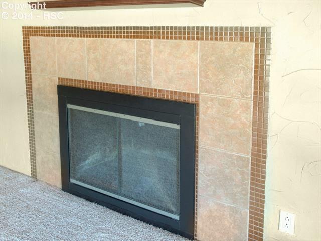 3827 Panorama Road Colorado Springs, CO 80907 - Photo 4 of 16 Wood burning fireplace with newer tile surround