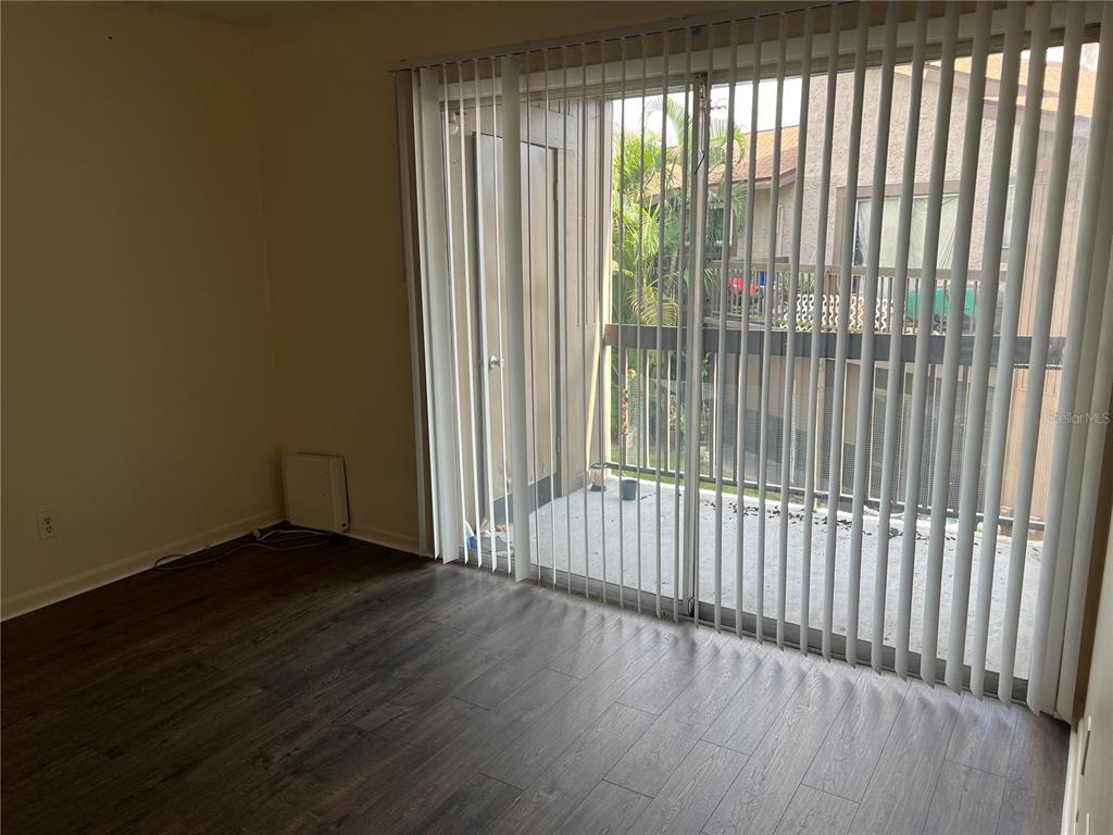 6312 Newtown Circle, Unit 12B3 Tampa, FL 33615 - Photo 2 of 10 a view of a porch with wooden floor