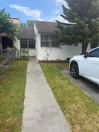 a view of a swimming pool with a yard