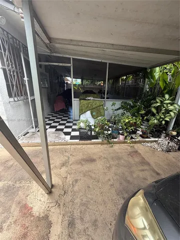 a view of a backyard with a garden and swimming pool