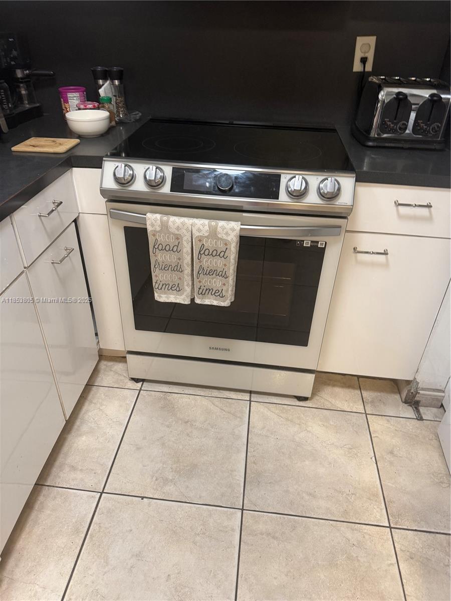 11472 Southwest 4th Street Sweetwater, FL 33174 - Photo 28 of 65 a stove top oven sitting inside of a kitchen