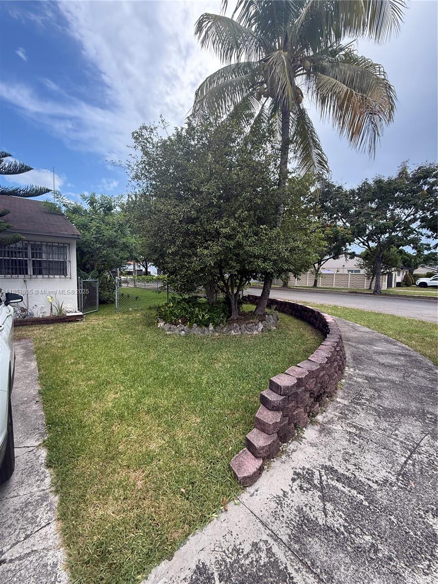 11472 Southwest 4th Street Sweetwater, FL 33174 - Photo 33 of 65 a view of a backyard with a garden and swimming pool