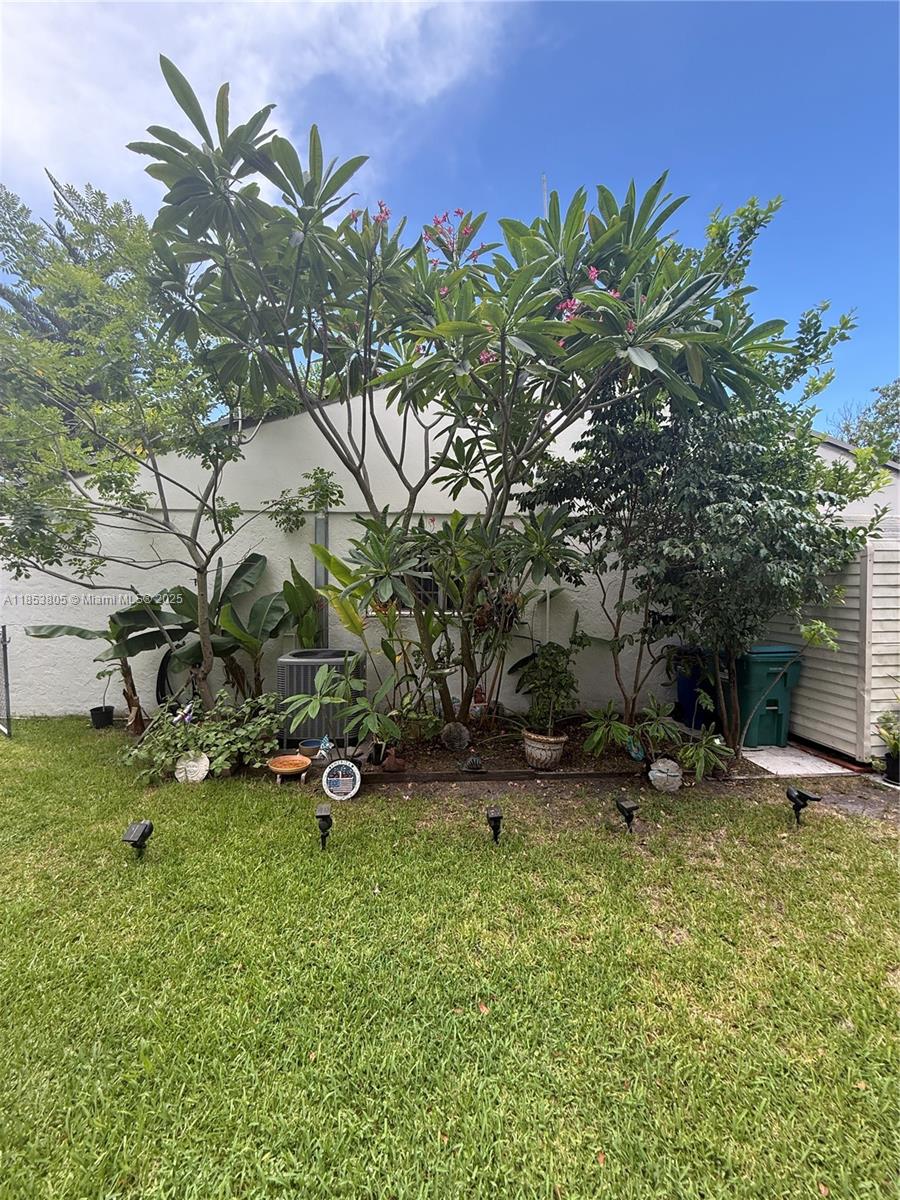 11472 Southwest 4th Street Sweetwater, FL 33174 - Photo 37 of 65 a backyard of a house with table and chairs