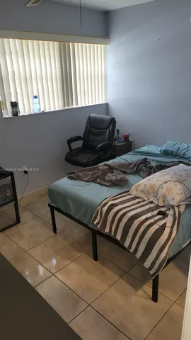 a bedroom with a bed and a night stand