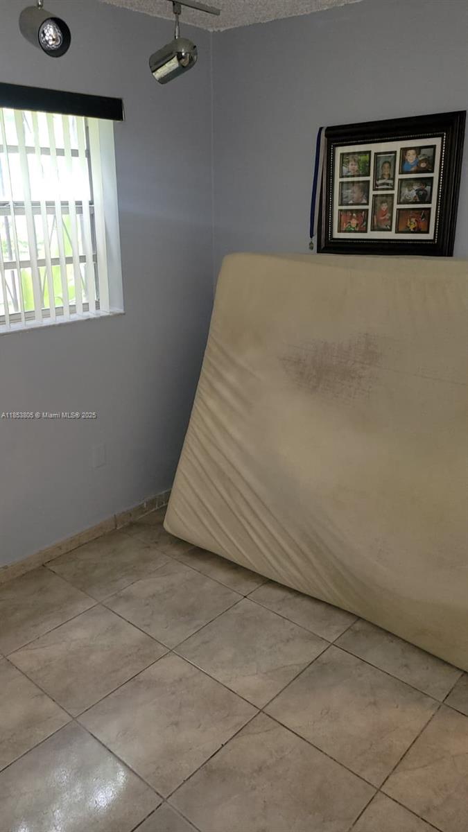 11472 Southwest 4th Street Sweetwater, FL 33174 - Photo 45 of 65 a bed sitting in a room next to a window