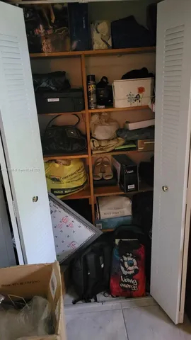 a bedroom with a bed and a mirror