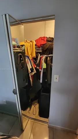 a bathroom with a toilet a sink and a mirror