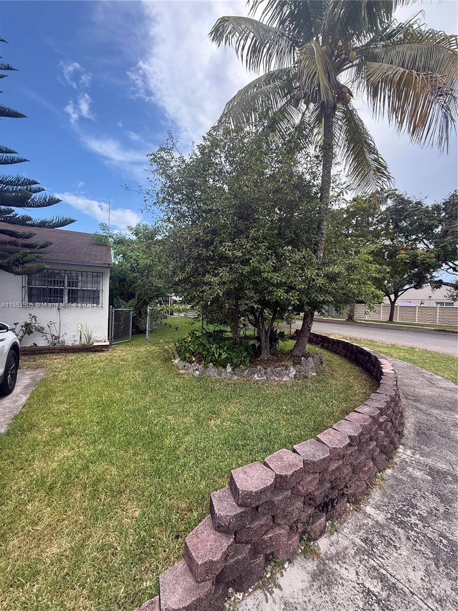 11472 Southwest 4th Street Sweetwater, FL 33174 - Photo 5 of 65 a view of a backyard with couches plants and large trees
